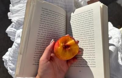 A book held open with a peach