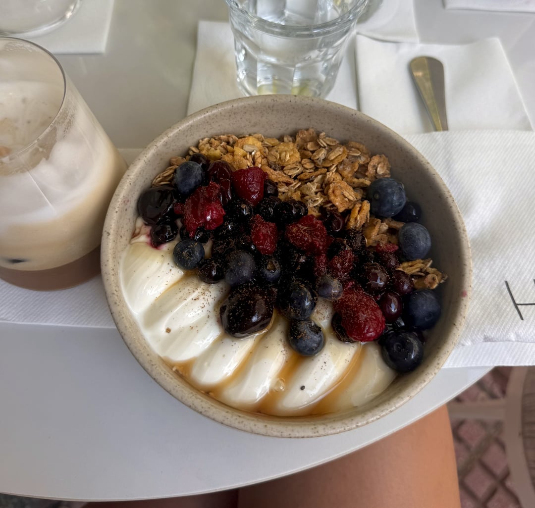 A yogurt breakfast bowl with berries and granola