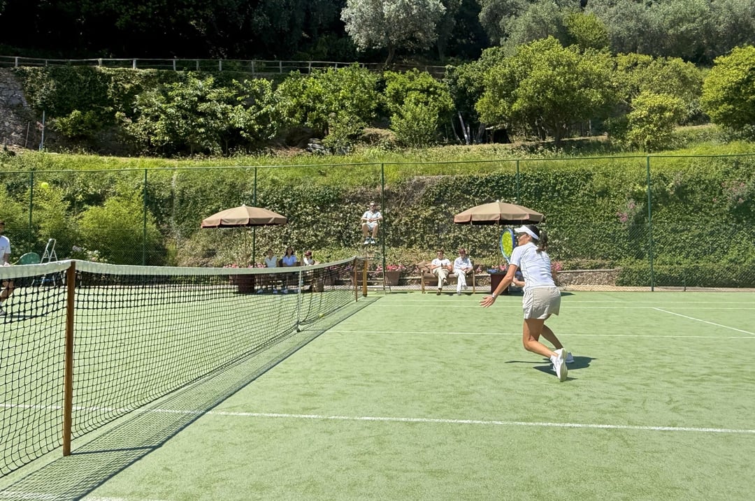 A tennis court among green hills